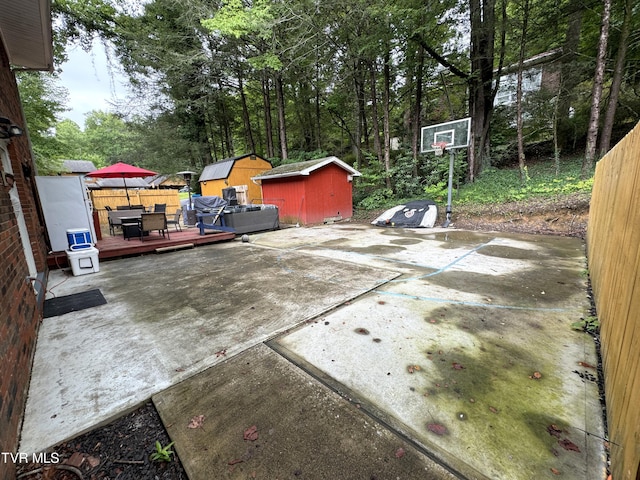 view of patio featuring a shed and a deck