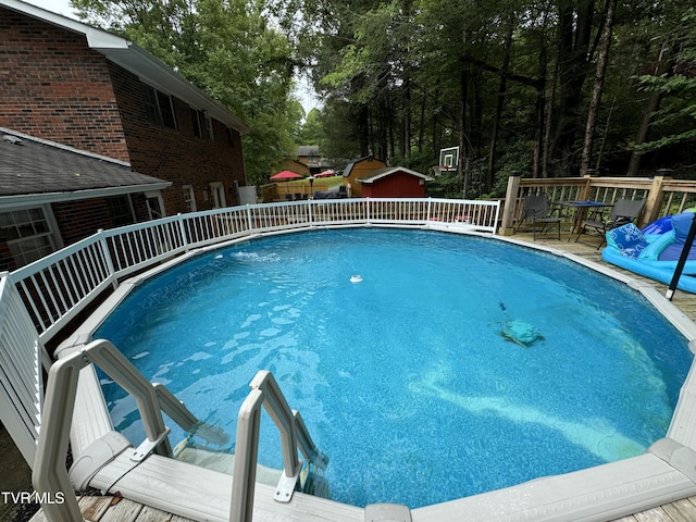 view of swimming pool featuring a deck