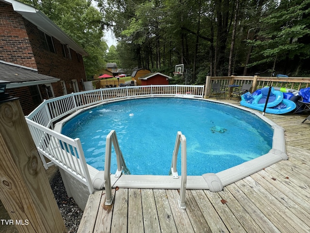 view of swimming pool with a wooden deck