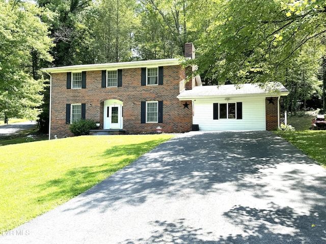 colonial home with a front lawn