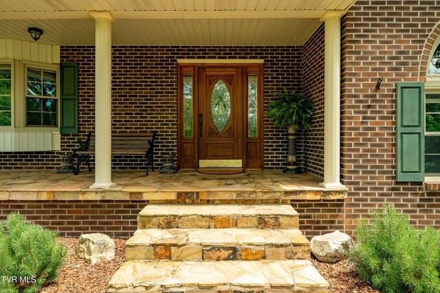 doorway to property with covered porch