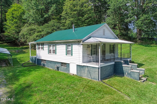 view of side of property with a porch and a yard