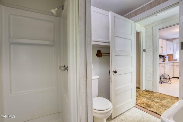 bathroom with toilet and tile patterned flooring