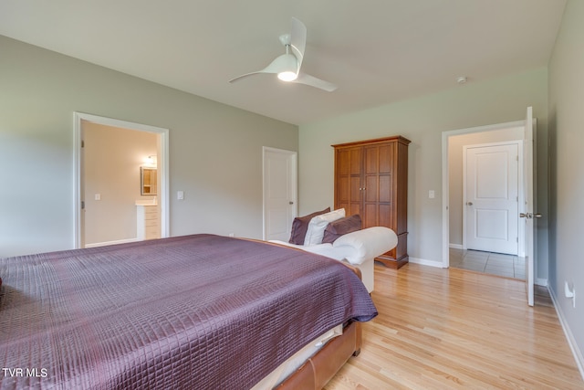 bedroom with ensuite bathroom, light wood-type flooring, and ceiling fan