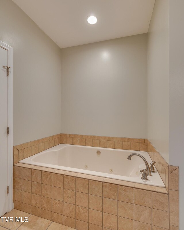 bathroom featuring tiled tub and tile patterned floors