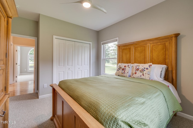 bedroom featuring a closet, ceiling fan, and light colored carpet