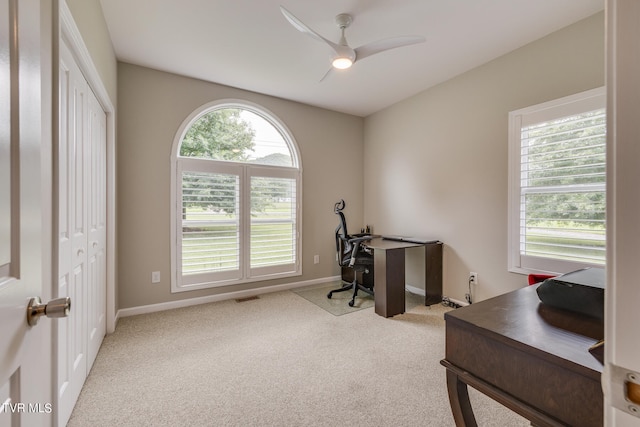 office with light carpet and ceiling fan