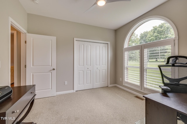 carpeted office with a healthy amount of sunlight and ceiling fan