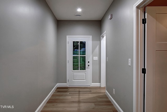 doorway with light wood-type flooring