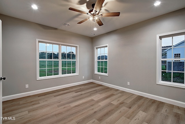 empty room featuring light wood-type flooring and ceiling fan