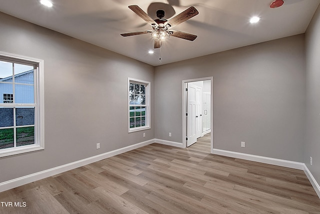 spare room with light hardwood / wood-style flooring and ceiling fan