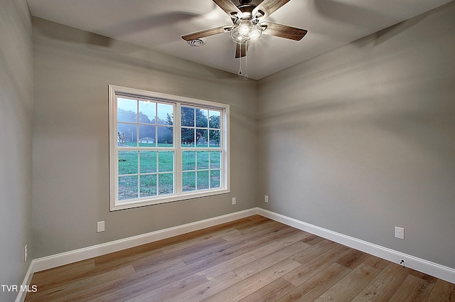 empty room featuring light hardwood / wood-style flooring and ceiling fan