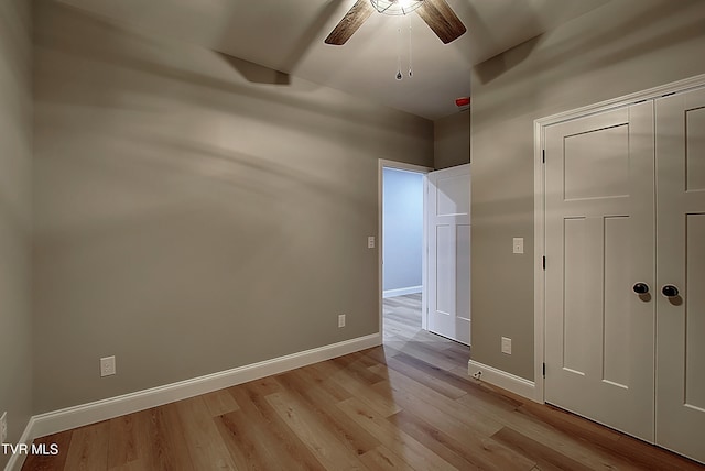 unfurnished bedroom with light hardwood / wood-style flooring, a closet, and ceiling fan