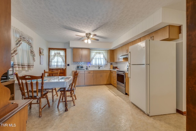 kitchen with stainless steel range with electric stovetop, a textured ceiling, ceiling fan, and white refrigerator