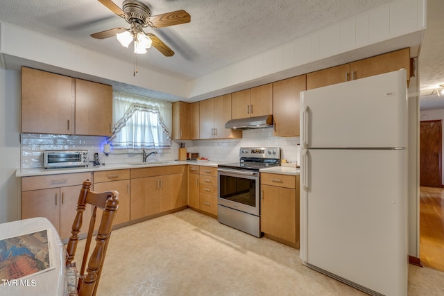 kitchen featuring white refrigerator, sink, decorative backsplash, stainless steel range with electric stovetop, and ceiling fan