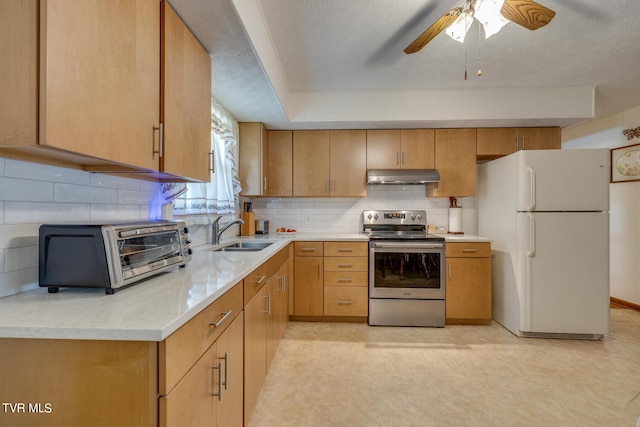 kitchen featuring white fridge, tasteful backsplash, ceiling fan, stainless steel range with electric cooktop, and sink