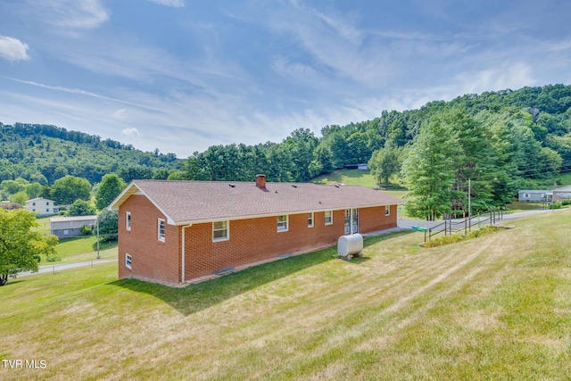 rear view of property with a lawn