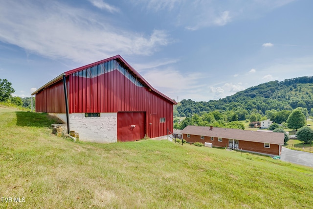 view of outbuilding featuring a yard