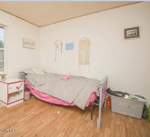 bedroom with wood finished floors