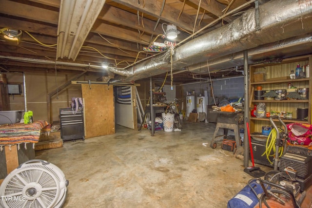 unfinished basement with concrete block wall and water heater