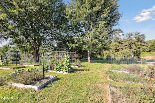 view of yard featuring a vegetable garden and fence