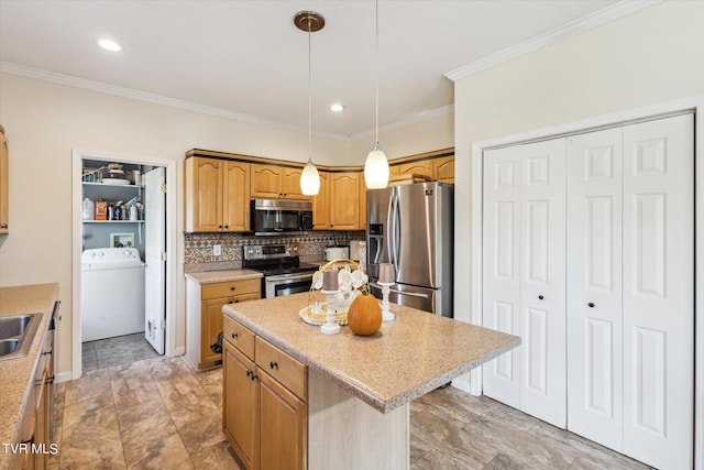 kitchen featuring washer / clothes dryer, light countertops, decorative backsplash, appliances with stainless steel finishes, and a kitchen island