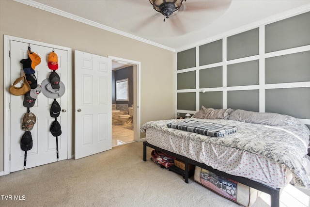 carpeted bedroom with ensuite bathroom and crown molding