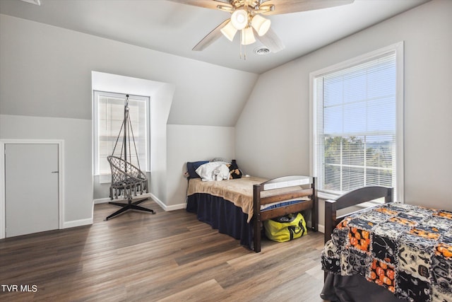 bedroom with vaulted ceiling, ceiling fan, wood finished floors, and baseboards