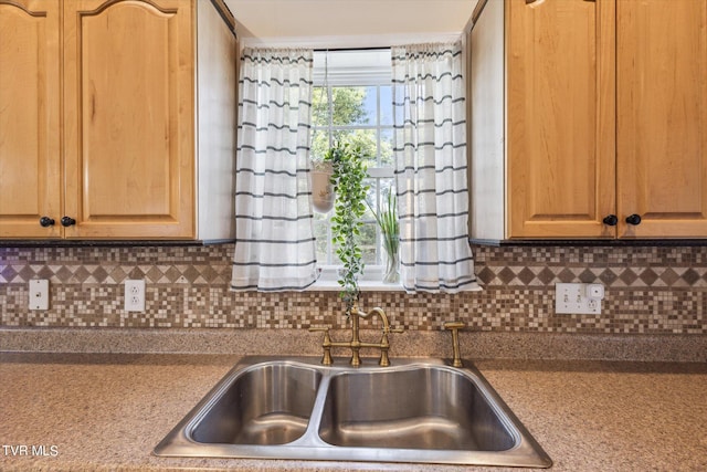 kitchen with decorative backsplash and a sink