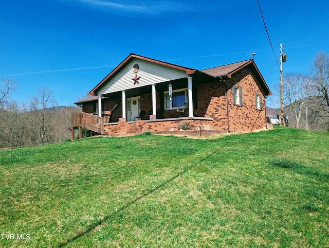 single story home featuring a porch and a front yard