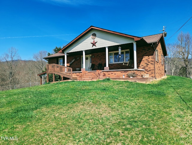 ranch-style house with covered porch and a front yard