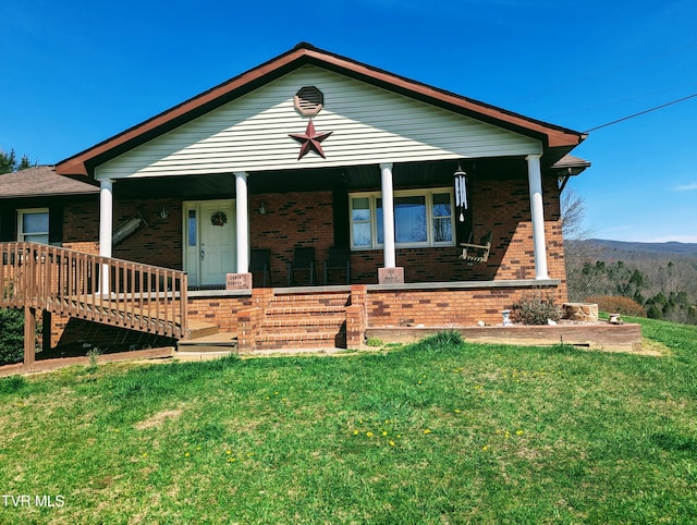 view of front of home with covered porch and a front yard