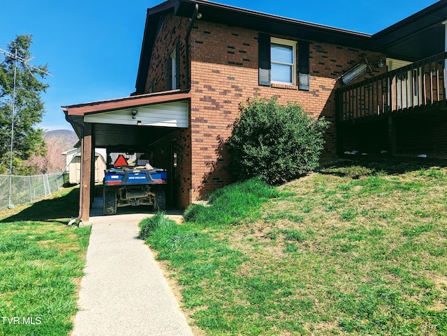 view of side of home featuring a carport and a yard