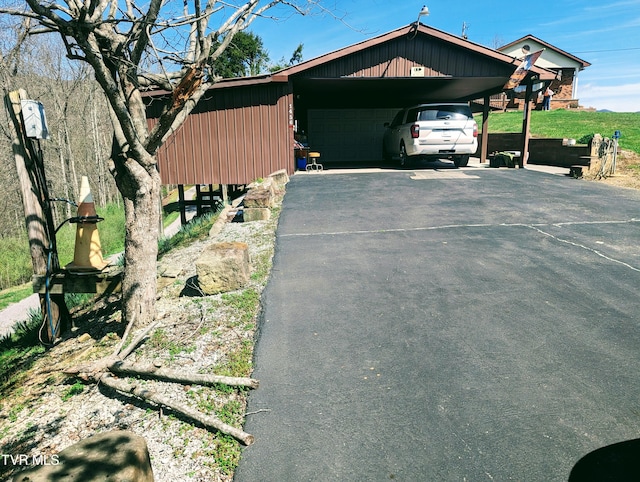 view of side of property featuring a garage and a carport