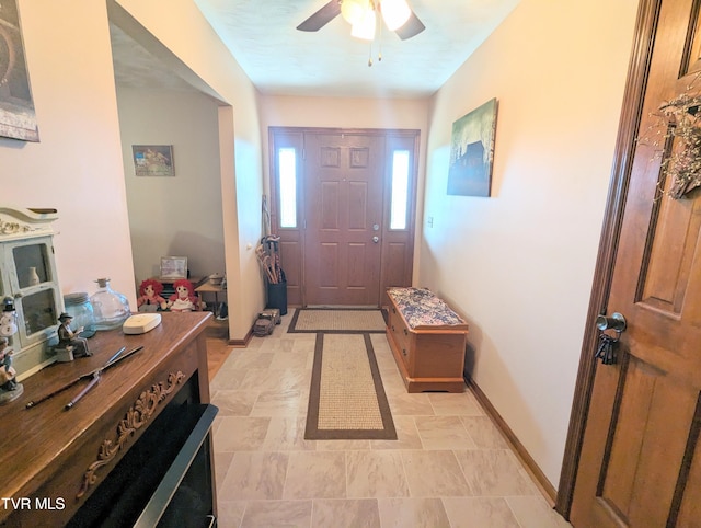 tiled entryway with ceiling fan