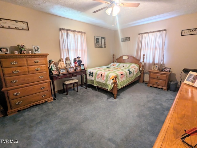 carpeted bedroom featuring a textured ceiling and ceiling fan