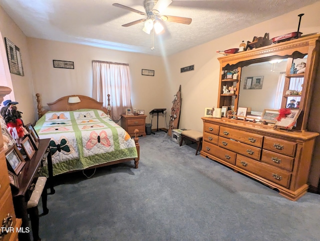 carpeted bedroom with a textured ceiling and ceiling fan