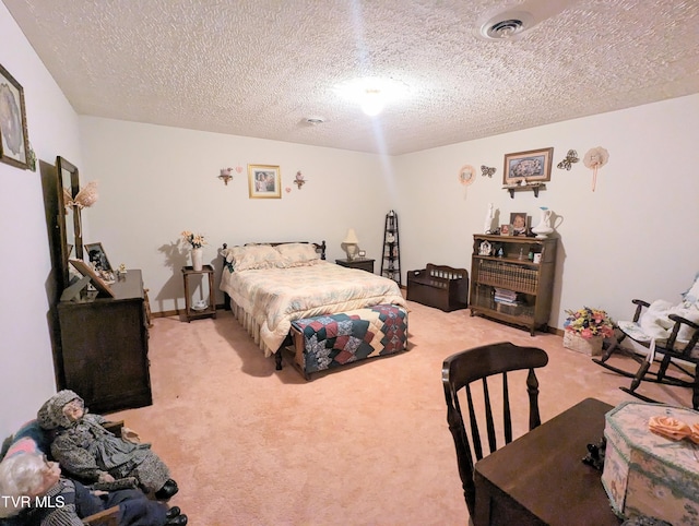 bedroom with a textured ceiling and light colored carpet