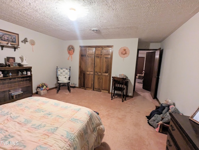 carpeted bedroom with a closet and a textured ceiling