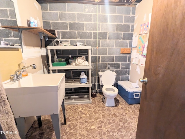 interior space with tile patterned flooring, toilet, and sink