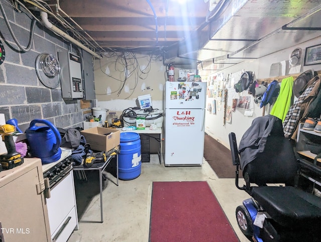 basement featuring white fridge and electric panel