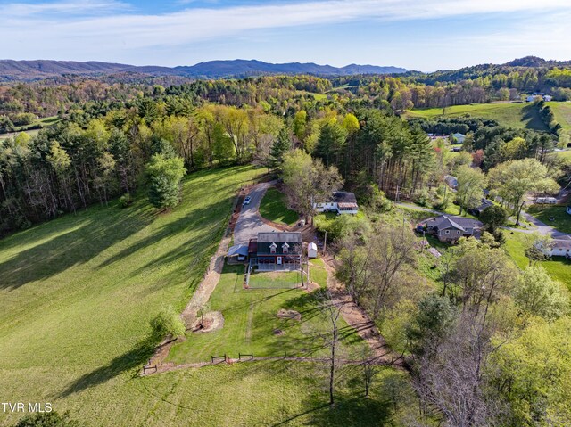 bird's eye view with a mountain view and a wooded view