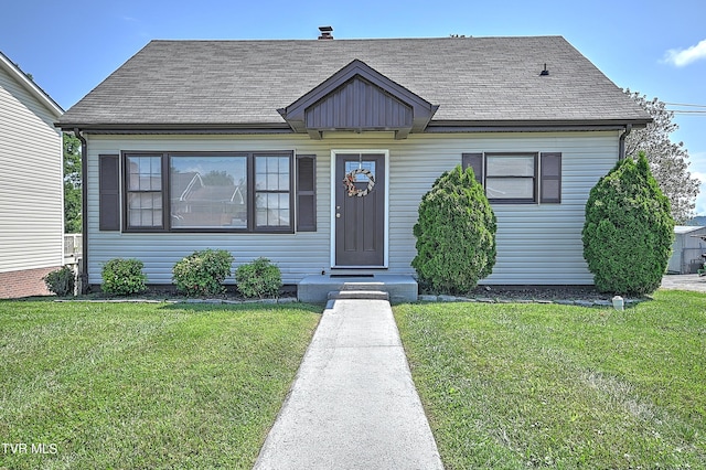 bungalow-style home with a front lawn