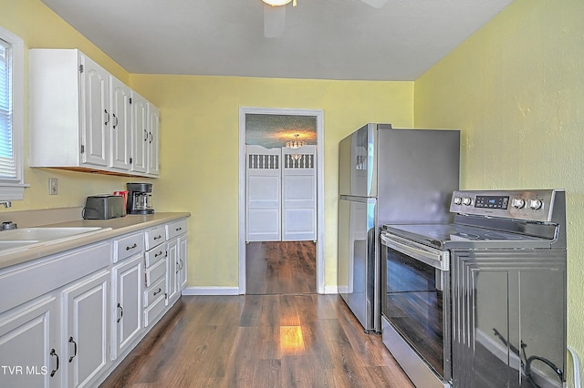 kitchen with stainless steel appliances, dark wood-type flooring, sink, and white cabinets