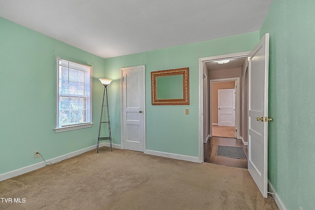 unfurnished bedroom with light carpet