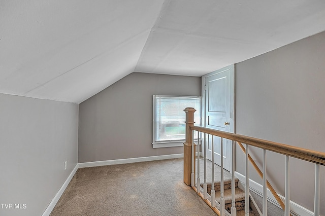 bonus room featuring lofted ceiling and carpet flooring