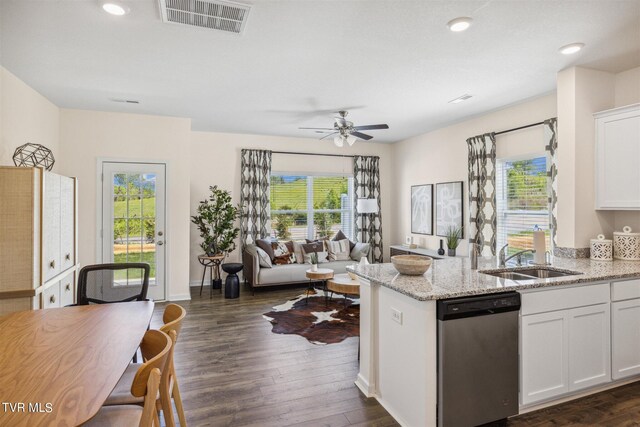 kitchen with dishwasher, dark hardwood / wood-style flooring, a wealth of natural light, and white cabinetry