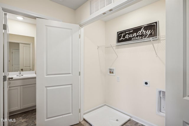 washroom featuring washer hookup, hookup for an electric dryer, sink, and dark tile patterned flooring