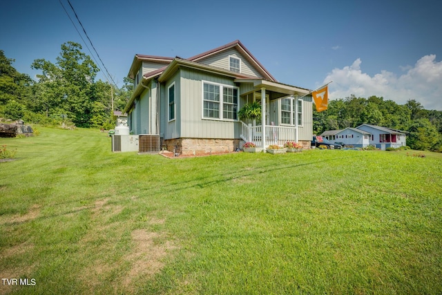 view of front facade with board and batten siding and a front yard