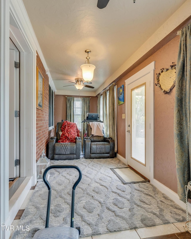 living area with a textured wall and baseboards